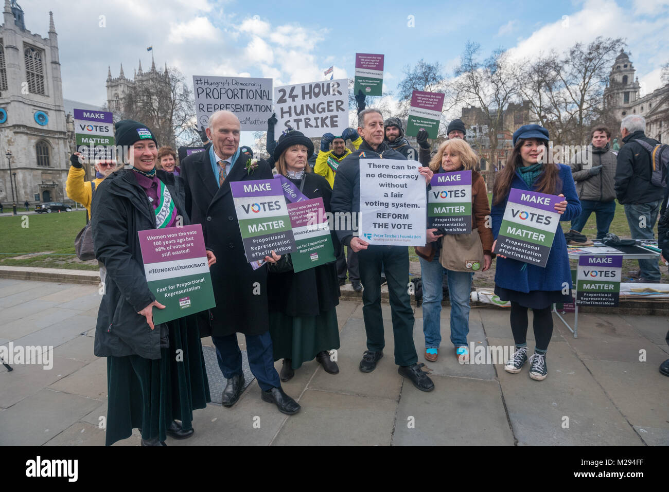 London, UK. 5 February 2018.  Campaigners, including VInce Cable and Peter Tatchell, pose in Parliament Square as hundreds of fair vote campaigners take part in a 24 hour hunger strike organised by Make Votes Matter (MVM) in protest against our dysfunctional electoral system and to urge Proportional Representation.  The event took place on the centenary of the 1918 the Representation of the People Act when for the first time some women and all men over 21 in the UK gained the right to vote. MVM point out that although now everyone can vote, for over two thirds of us our vote has no effect on t Stock Photo