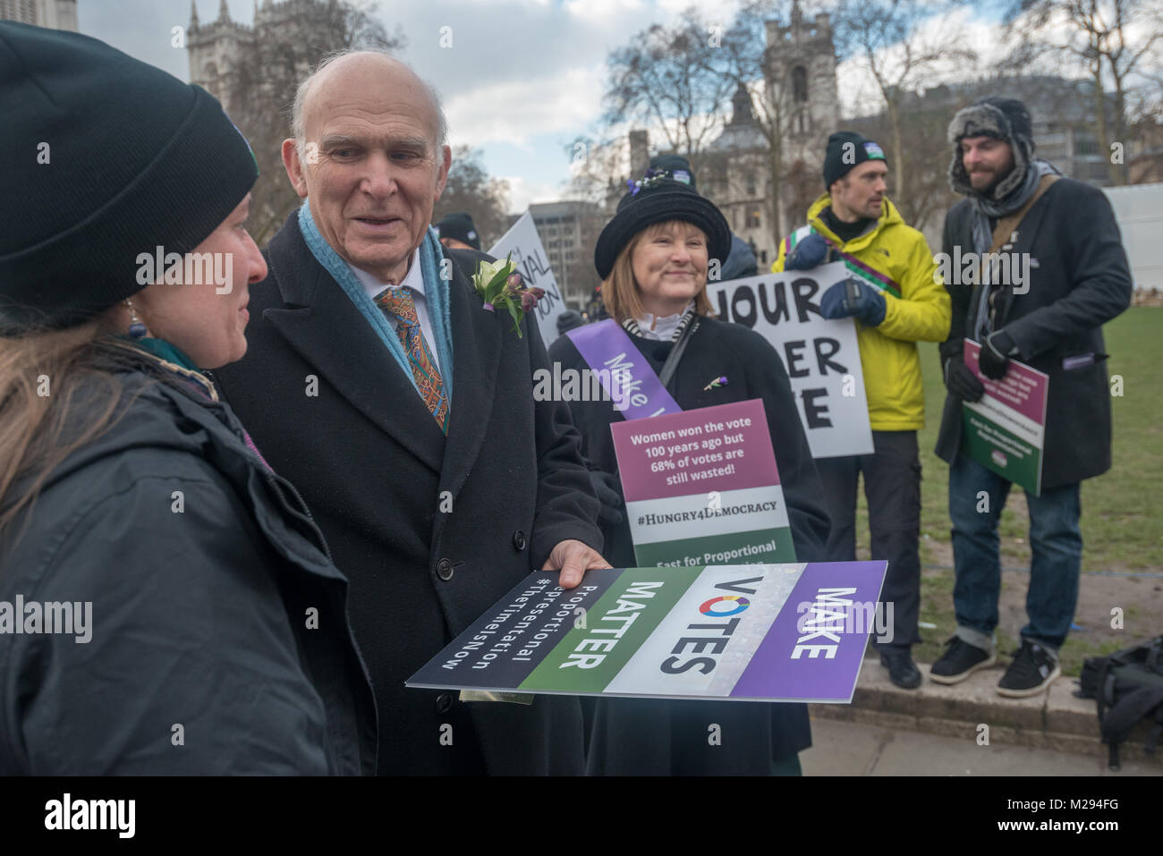 London, UK. 5 February 2018.  Vince Cable talks with other campaigners posing in Parliament Square as hundreds of fair vote campaigners take part in a 24 hour hunger strike organised by Make Votes Matter (MVM) in protest against our dysfunctional electoral system and to urge Proportional Representation.  The event took place on the centenary of the 1918 the Representation of the People Act when for the first time some women and all men over 21 in the UK gained the right to vote. MVM point out that although now everyone can vote, for over two thirds of us our vote has no effect on the result, ' Stock Photo