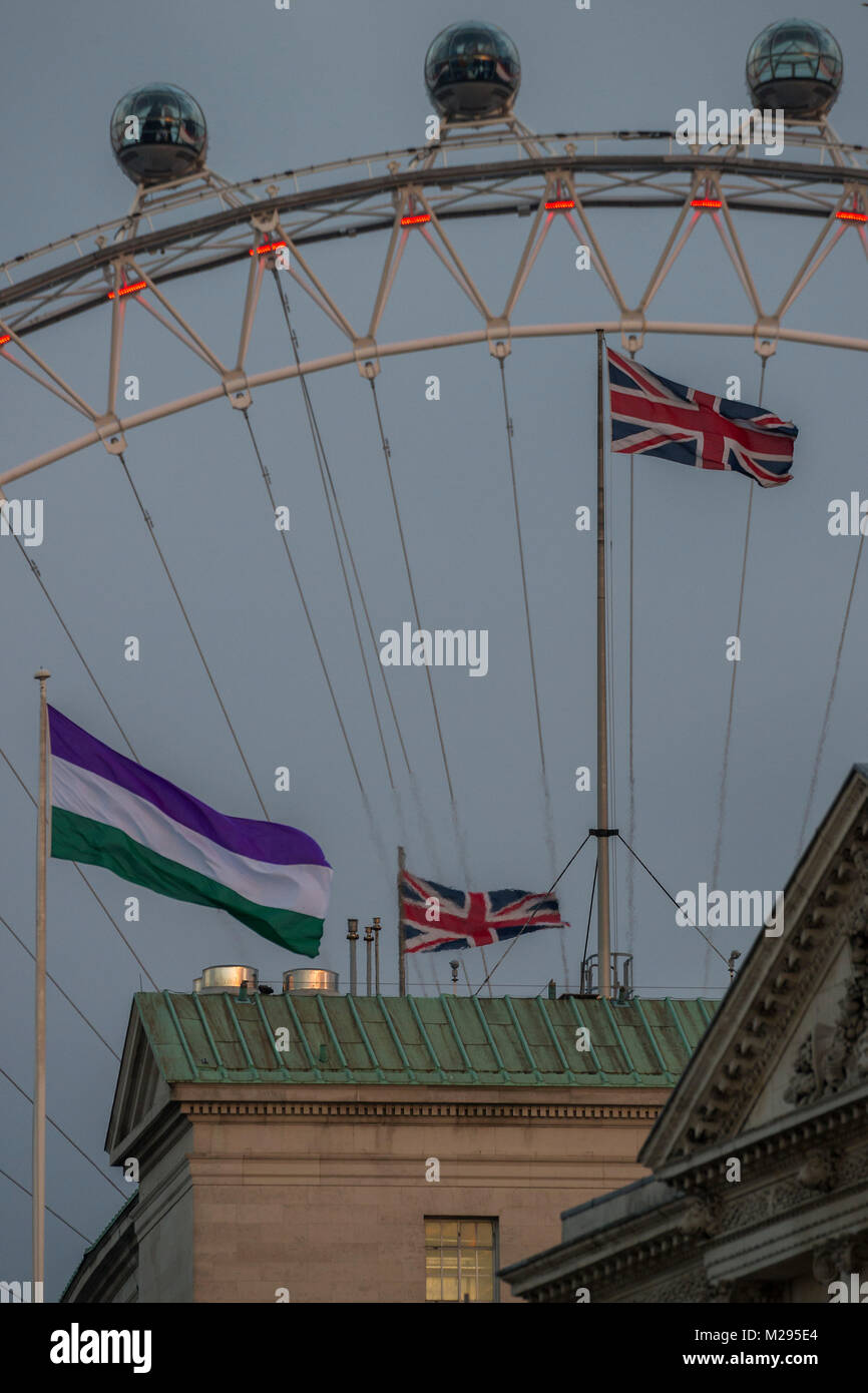 London, UK. 6th Feb, 2018. The Suffrage flag flies over Whitehall at the back of Downing Street. It coincides with the 100 year anniversary of the 1918 Representation of the People Act, which gave some women the vote, and was introduced thanks to the campaigning of suffragists and suffragettes. Credit: Guy Bell/Alamy Live News Stock Photo