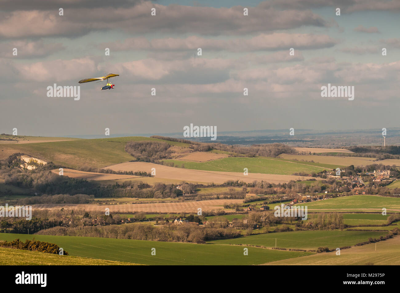 Firle Beacon. East Sussex. 6th Feb, 2018. UK Weather. Hardy experienced Hanglider pilots take advantage of the cold prevailing North wind over the South Downs in the glorious Sussex countryside. Stock Photo