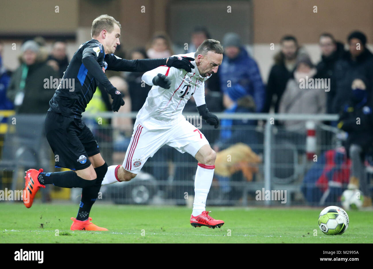 (180207) -- PADERBORN, Feb. 7, 2018(Xinhua) -- Franck Ribery (R) of Bayern Munich vies with Ben Zolinski of Paderborn during the quarterfinal match of German Cup between SC Paderborn and Bayern Munich at Benteler Arena in Paderborn, Germany, on Feb. 6, 2018. Bayern Munich won 6-0. (Xinhua/Ulrich Hufnagel) Stock Photo