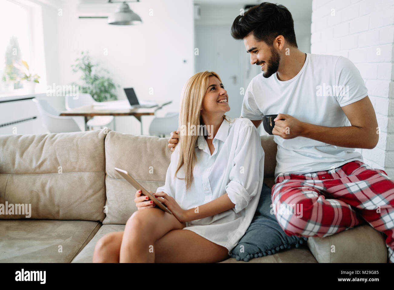 Young attractive couple spending time together at home Stock Photo - Alamy