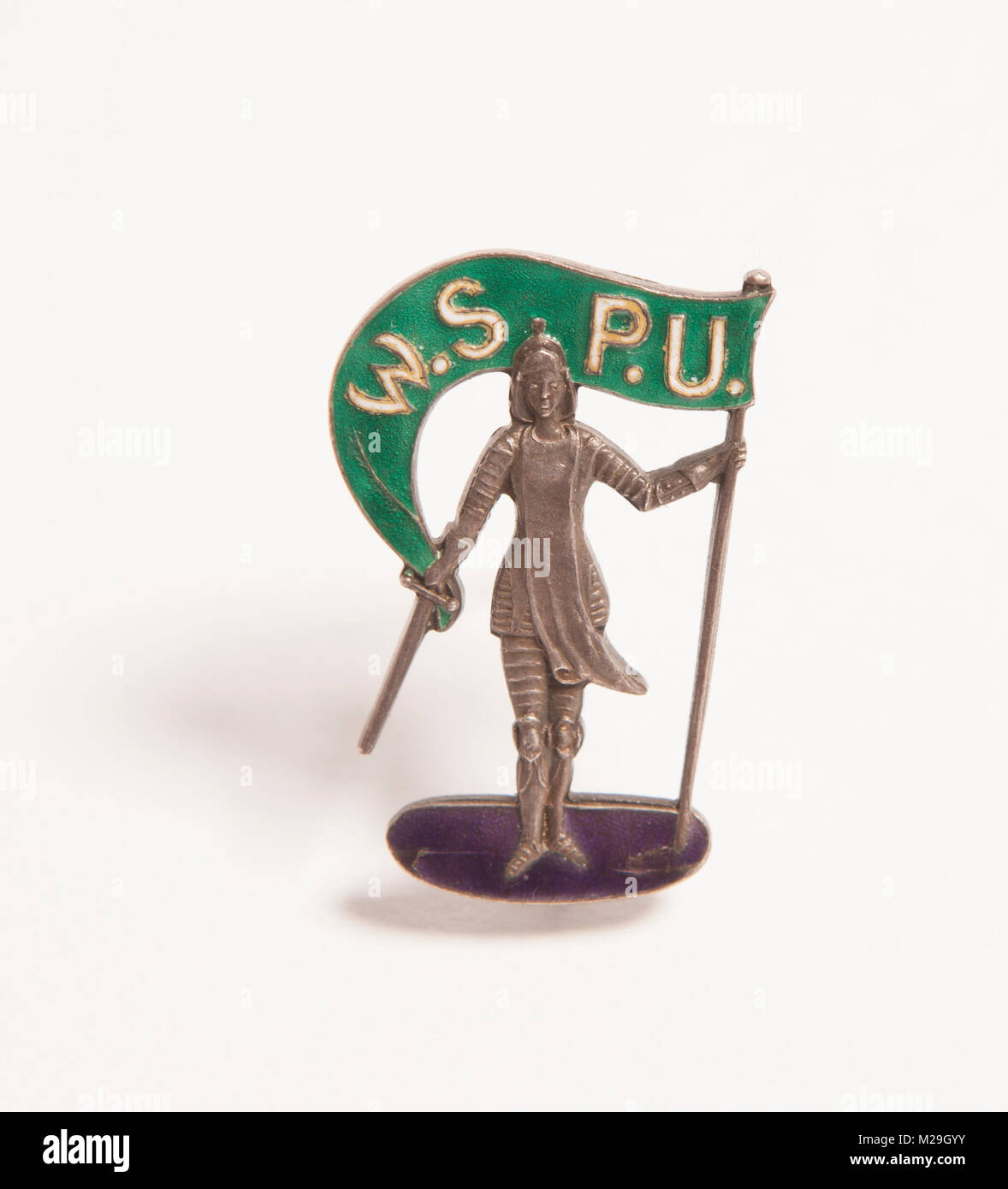 A silver enamel brooch in the green & violet colours of the women's suffrage or suffragette movement with Joan of Arc holding a WSPU banner Stock Photo
