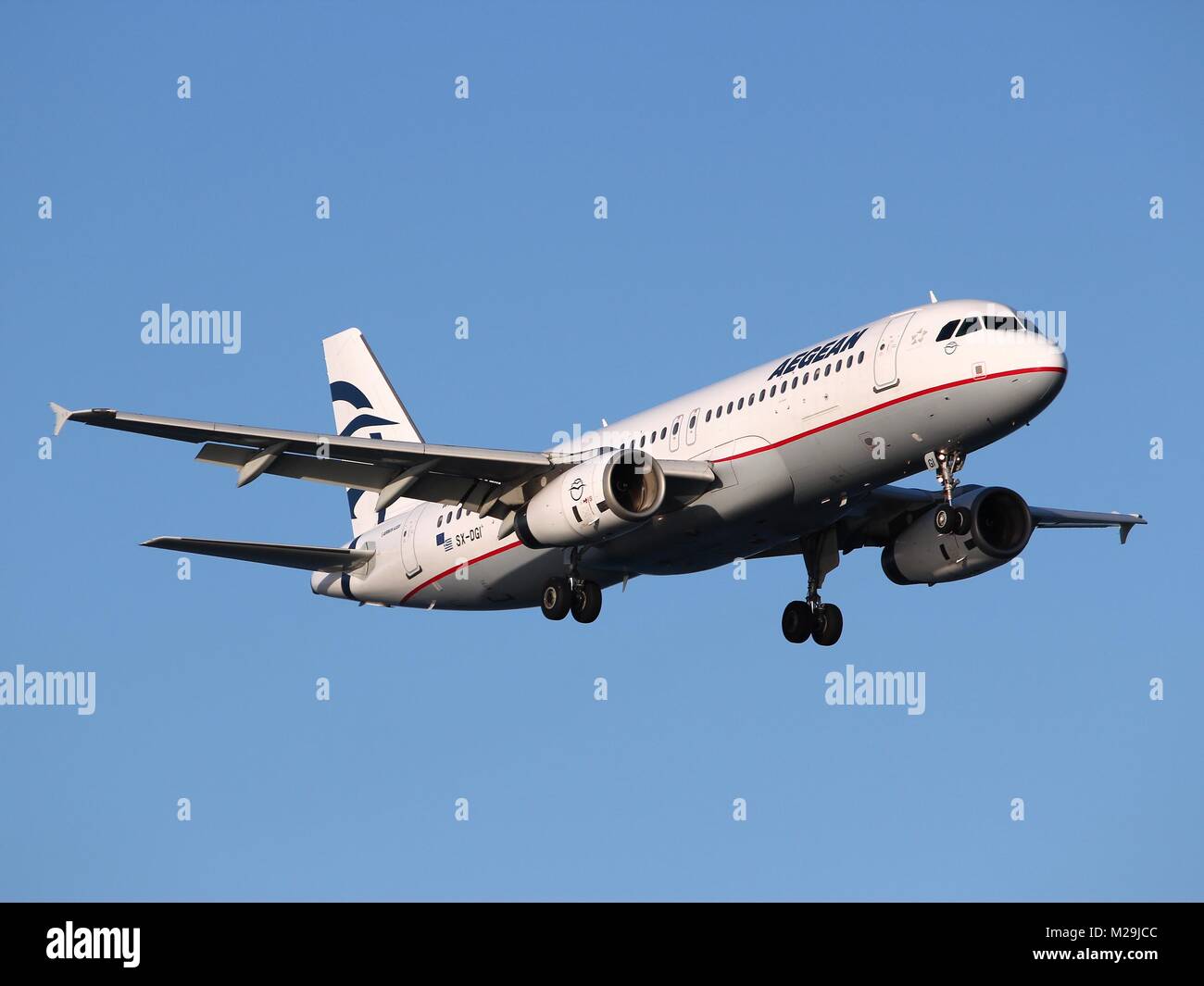 LARNACA, CYPRUS - MAY 17, 2014: Aegean Airlines Airbus A320 lands in Larnaca International Airport. It is the largest Greek airline and carried 6.9 mi Stock Photo