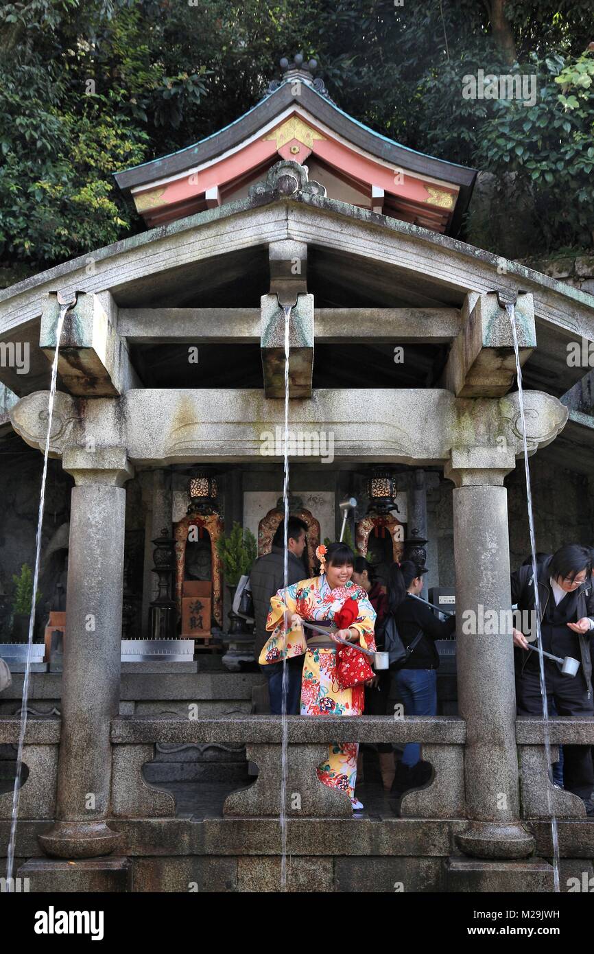 KYOTO, JAPAN - NOVEMBER 26, 2016: People visit Otowa Waterfall at Kiyomizu-dera Temple in Kyoto, Japan. Each of the 3 streams brings different effect: Stock Photo