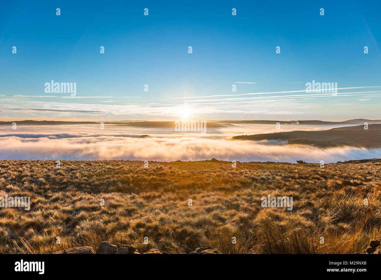 Fantastic view on a foggy and sunny day at the District National Park. The mountain peaks are visible through the fog that extends beyond the horizon. Stock Photo
