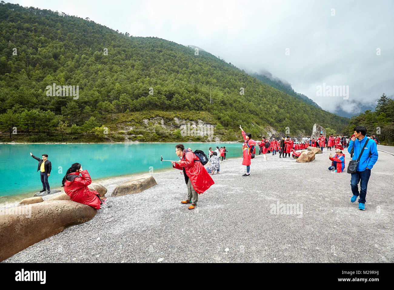 Lijiang, China - September 22, 2017: Tourists at the White Water River in Blue Moon Valley, one of the China top travel destinations. Stock Photo