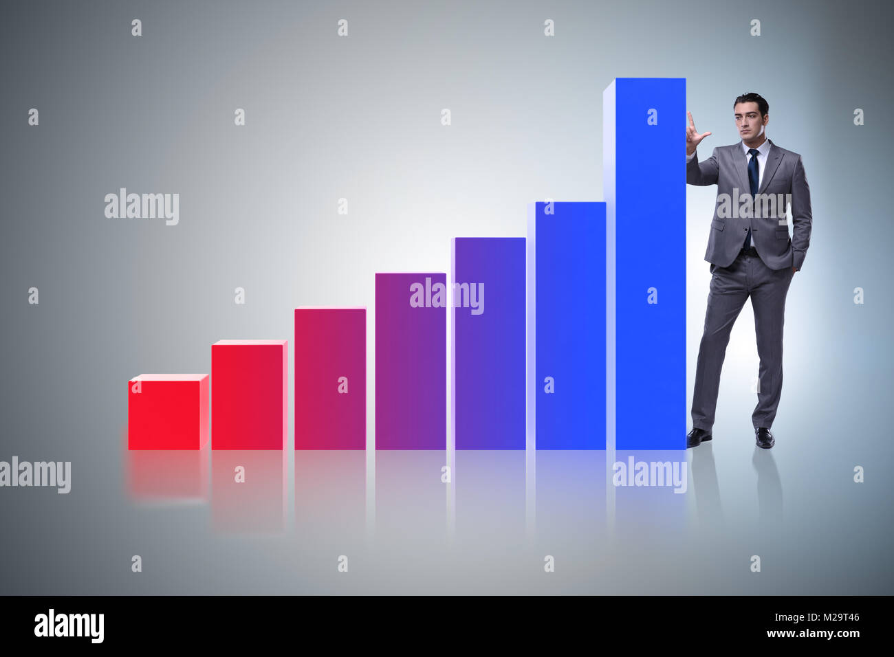 Businessman standing next to bar chart in business concept Stock Photo ...