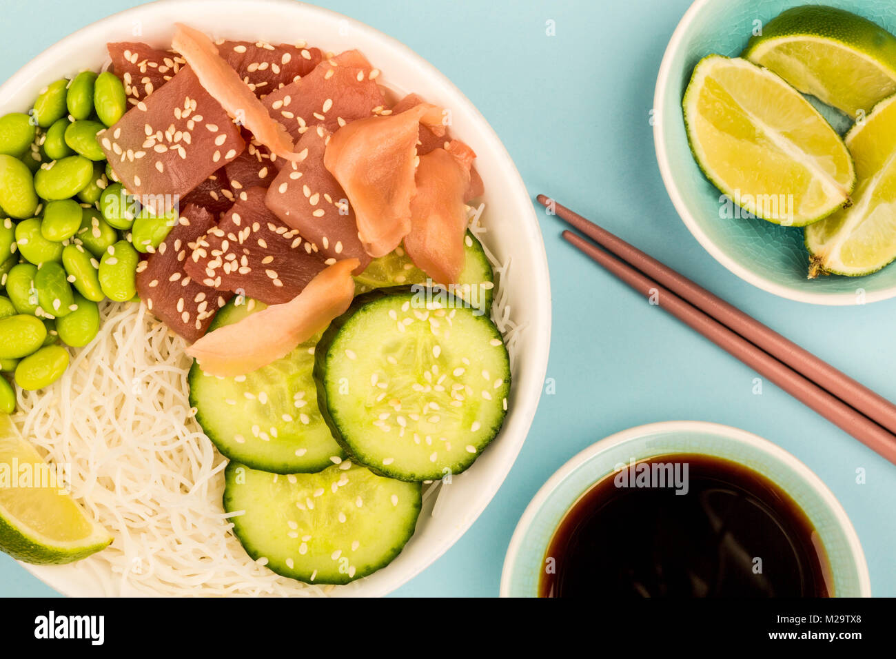 Hawaiian Tuna Fish Poke bowl With Noodles and Edamame Beans Against A
