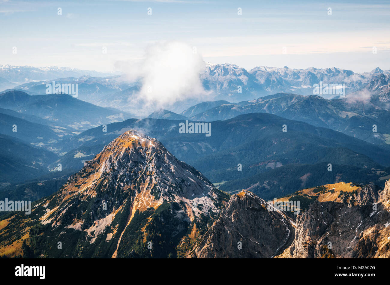 Aerial view of mountain of Dachstein plateau ski resort with cloud on top looking like volcano. Austria Stock Photo