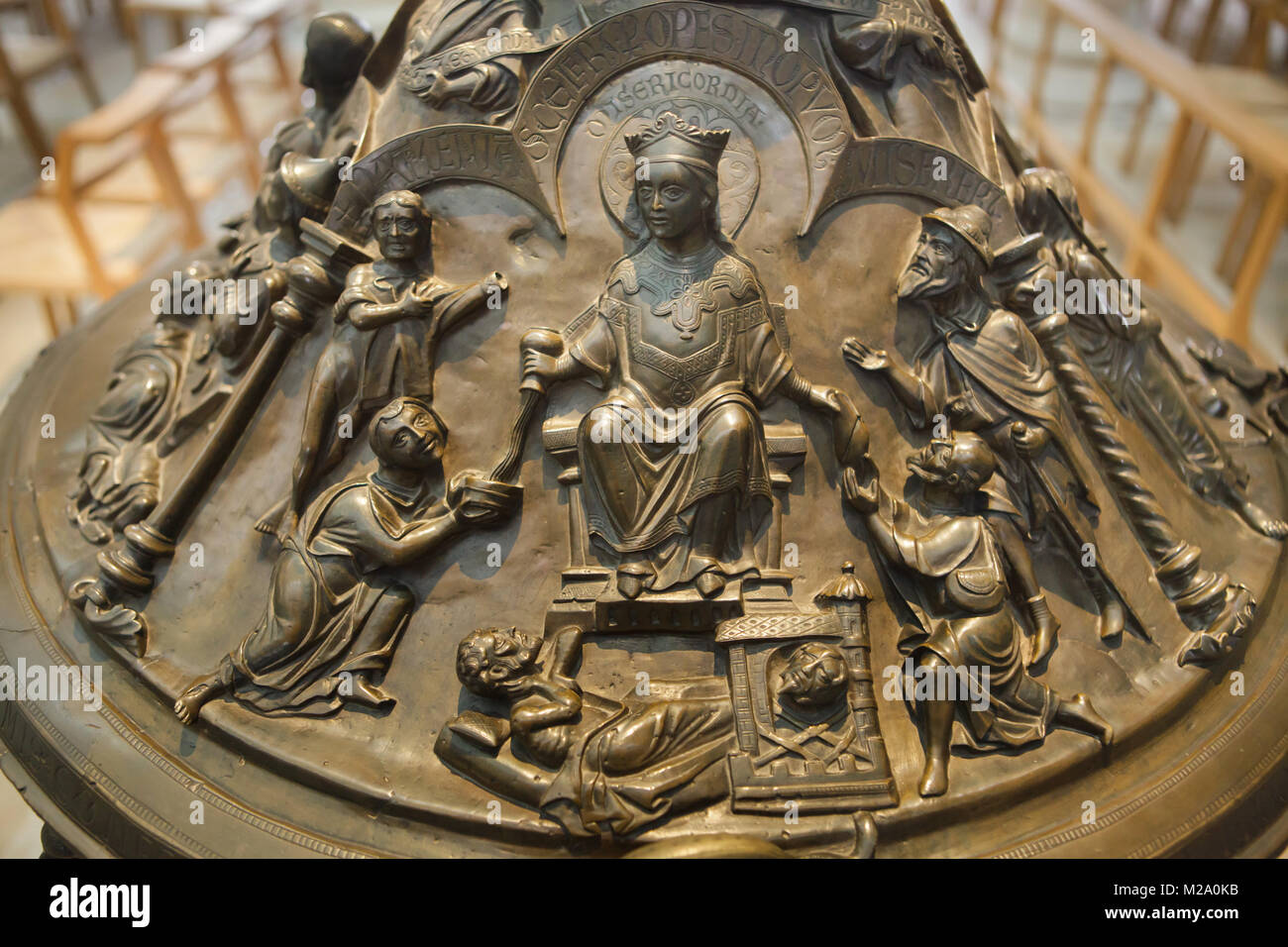 Personification of Mercy. Romanesque relief on the cover of the bronze baptismal font (Bronzetaufe) from the 11th century in the Hildesheim Cathedral (Hildesheimer Dom) in Hildesheim in Lower Saxony, Germany. Stock Photo