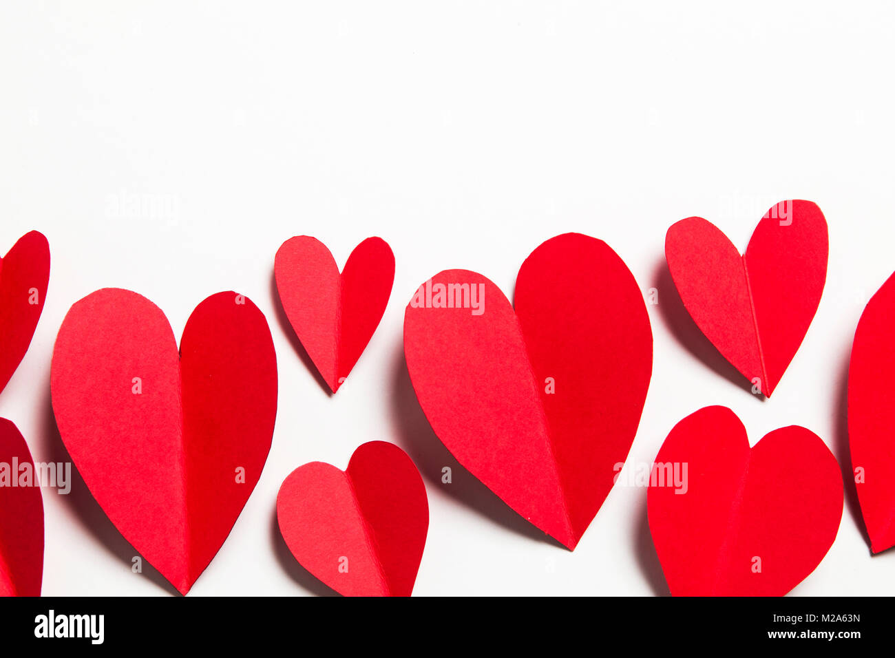 Red handmade paper hearts on a white background Stock Photo - Alamy