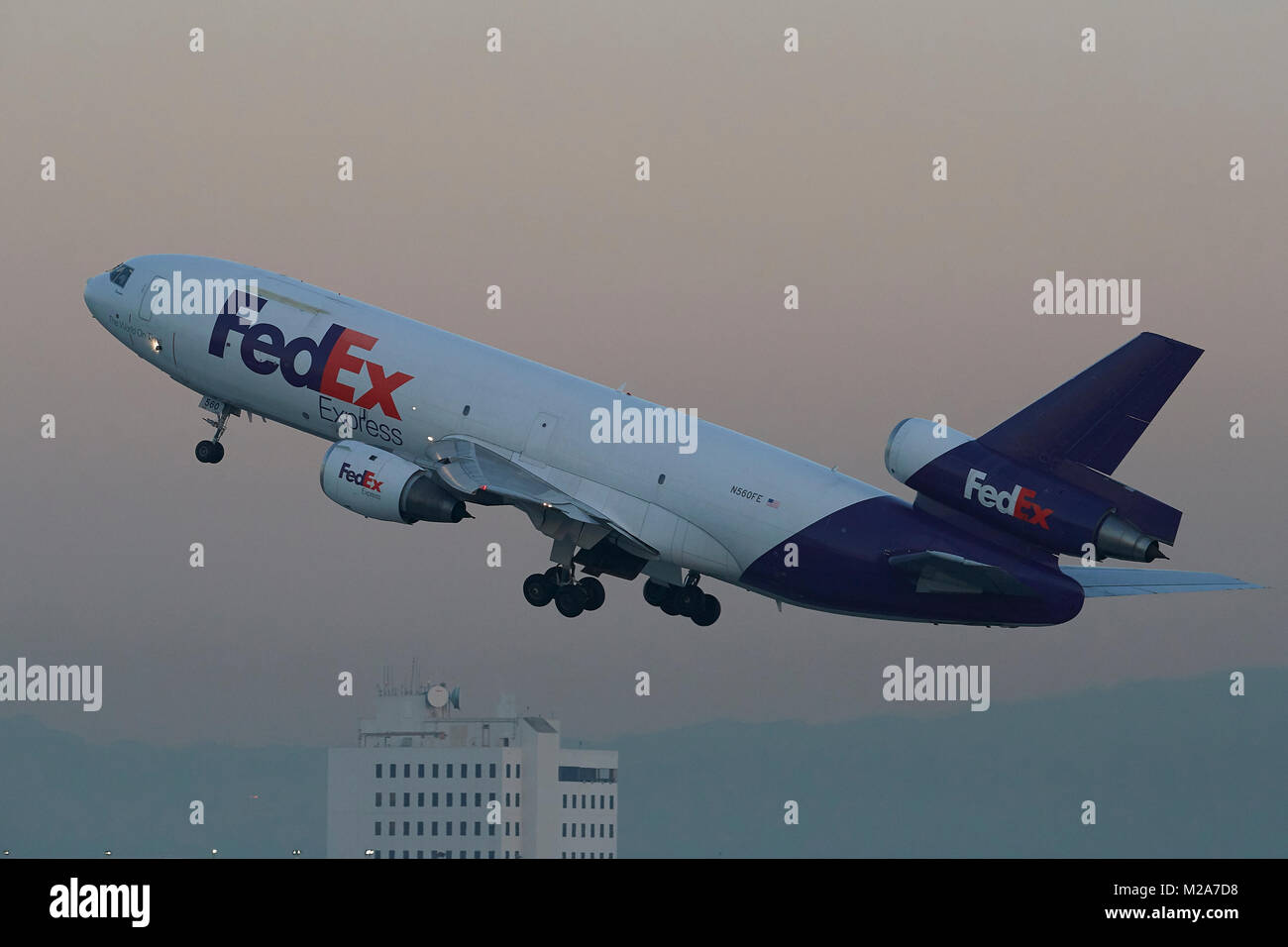 Sunrise Take Off Of A Vintage Federal Express, FedEx Express, DC-10 Jet Freighter At Los Angeles International Airport, LAX, California, USA. Stock Photo