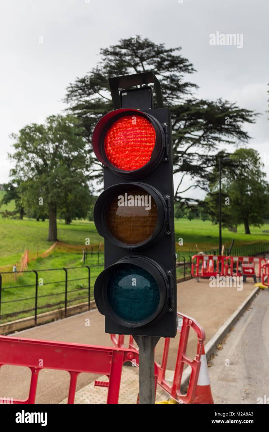 Temporary traffic control lights showing red signalling to stop Stock Photo