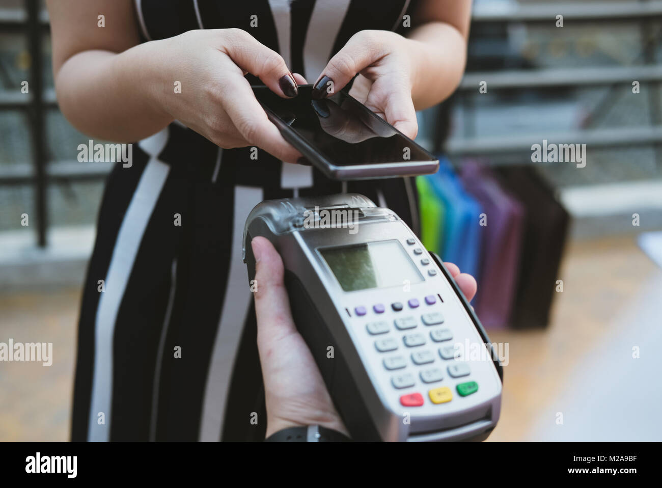 woman use smartphone to make mobile payment with electronic reader ...