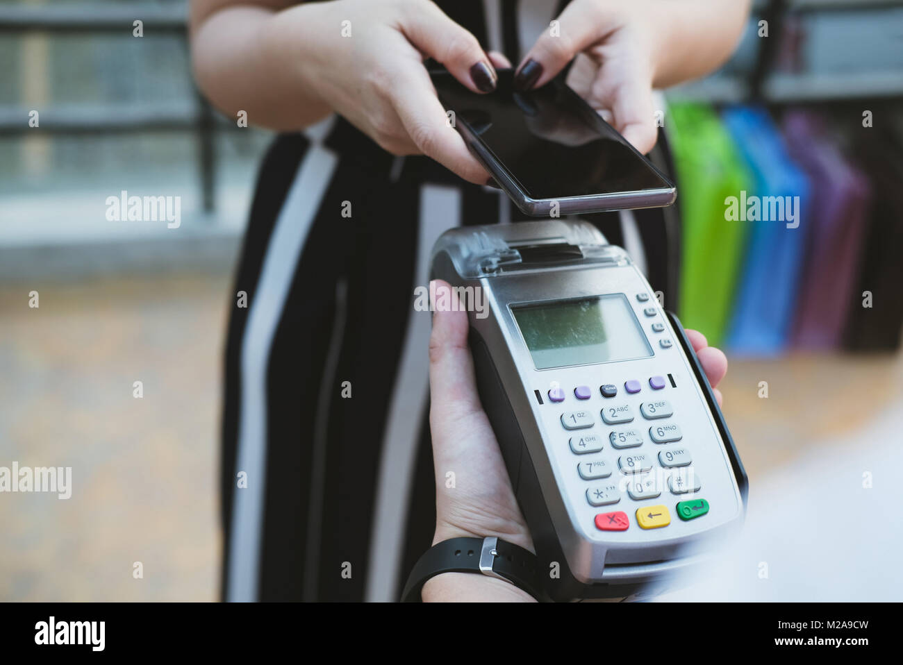 woman use smartphone to make mobile payment with electronic reader ...