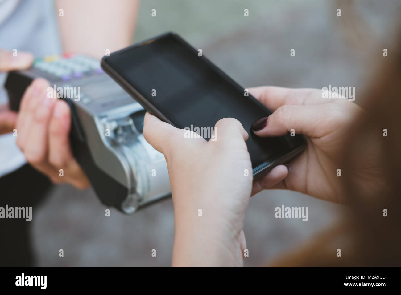 woman use smartphone to make mobile payment with electronic reader ...