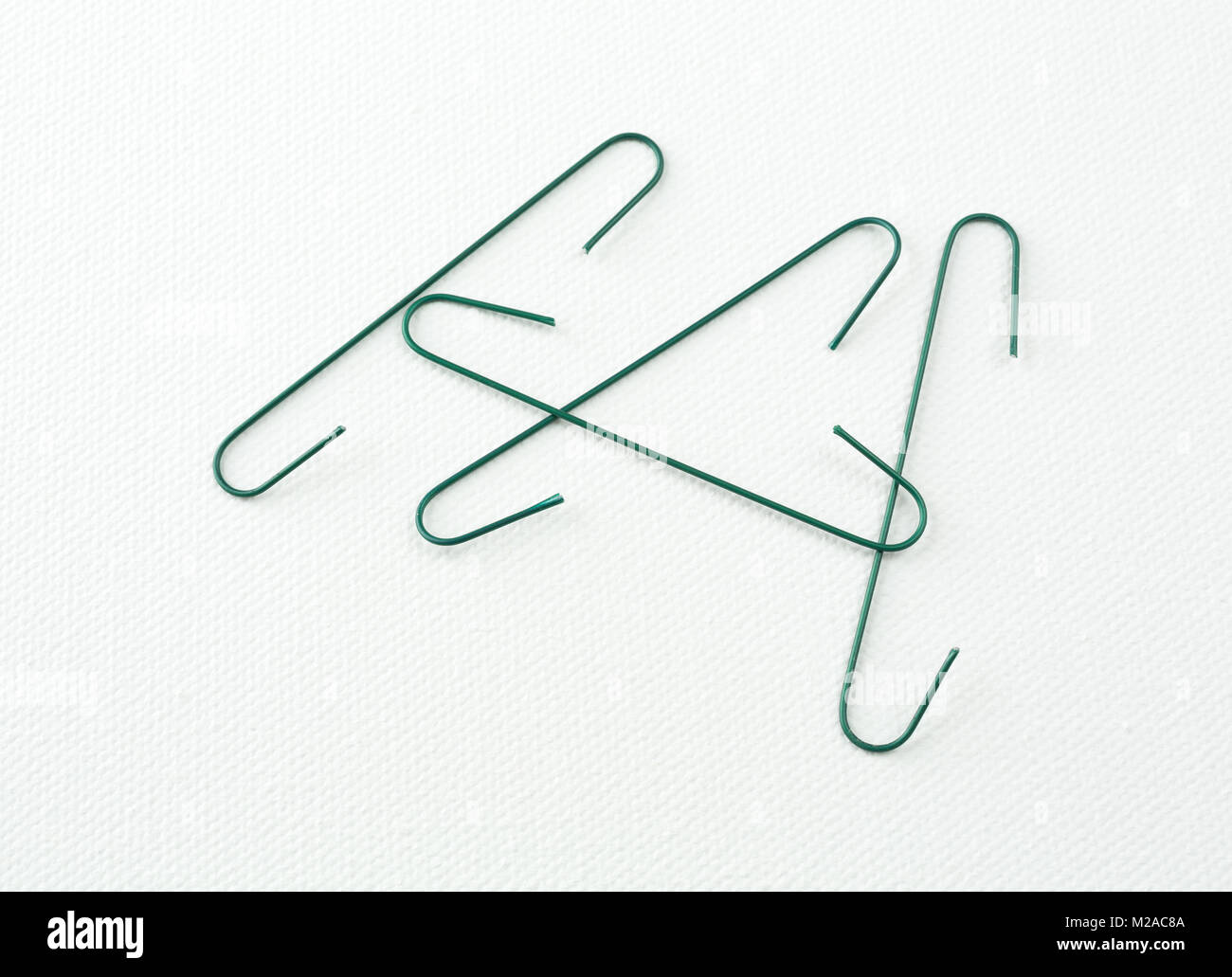 Several green Christmas ornament hangers on a white background Stock