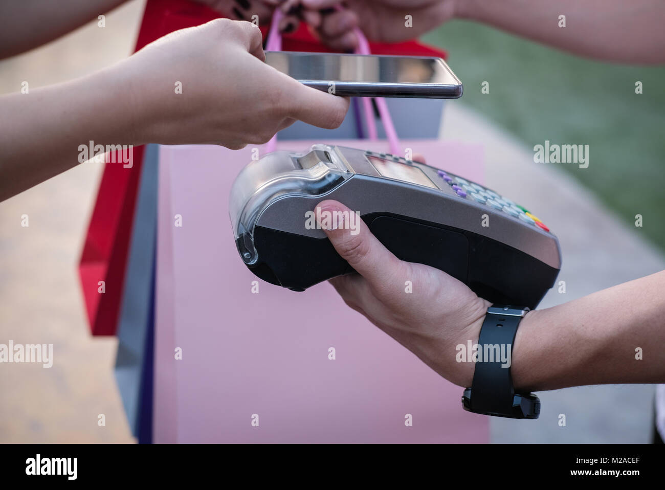 woman use smartphone to make mobile payment with electronic reader ...