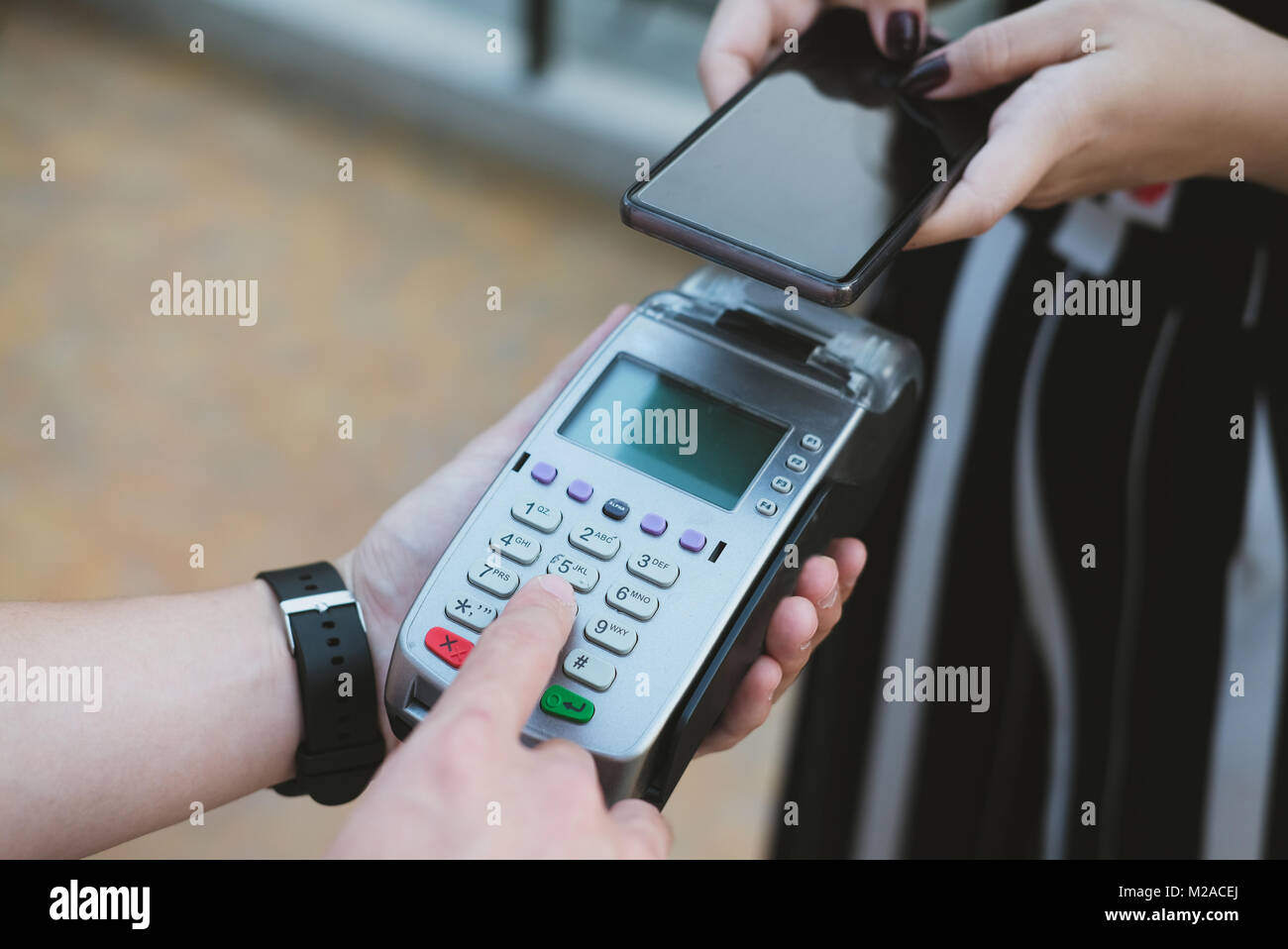 woman use smartphone to make mobile payment with electronic reader ...