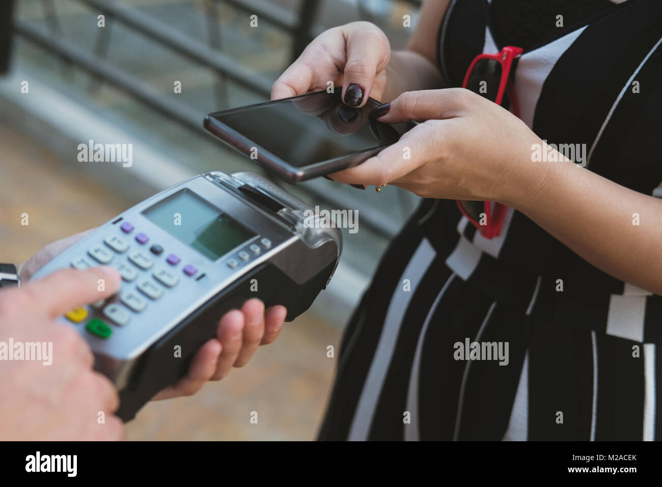woman use smartphone to make mobile payment with electronic reader ...