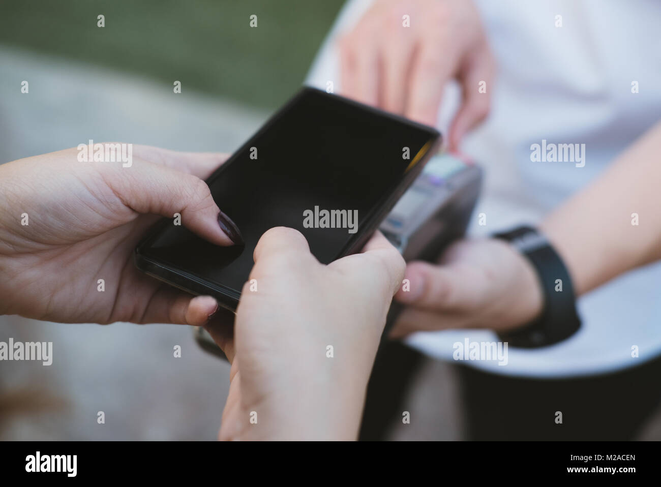 woman use smartphone to make mobile payment with electronic reader ...