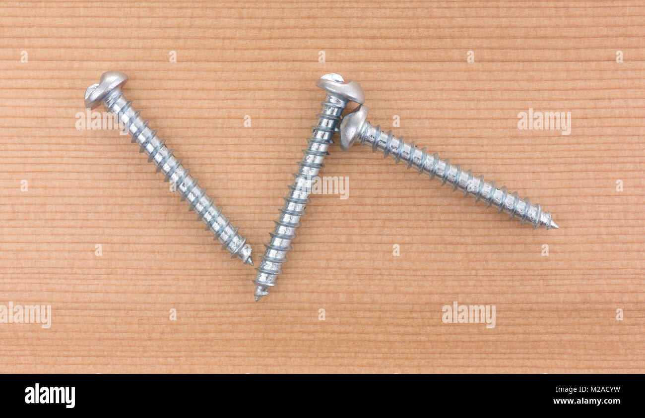 Top view of three round head tamper proof sheet metal screws on a