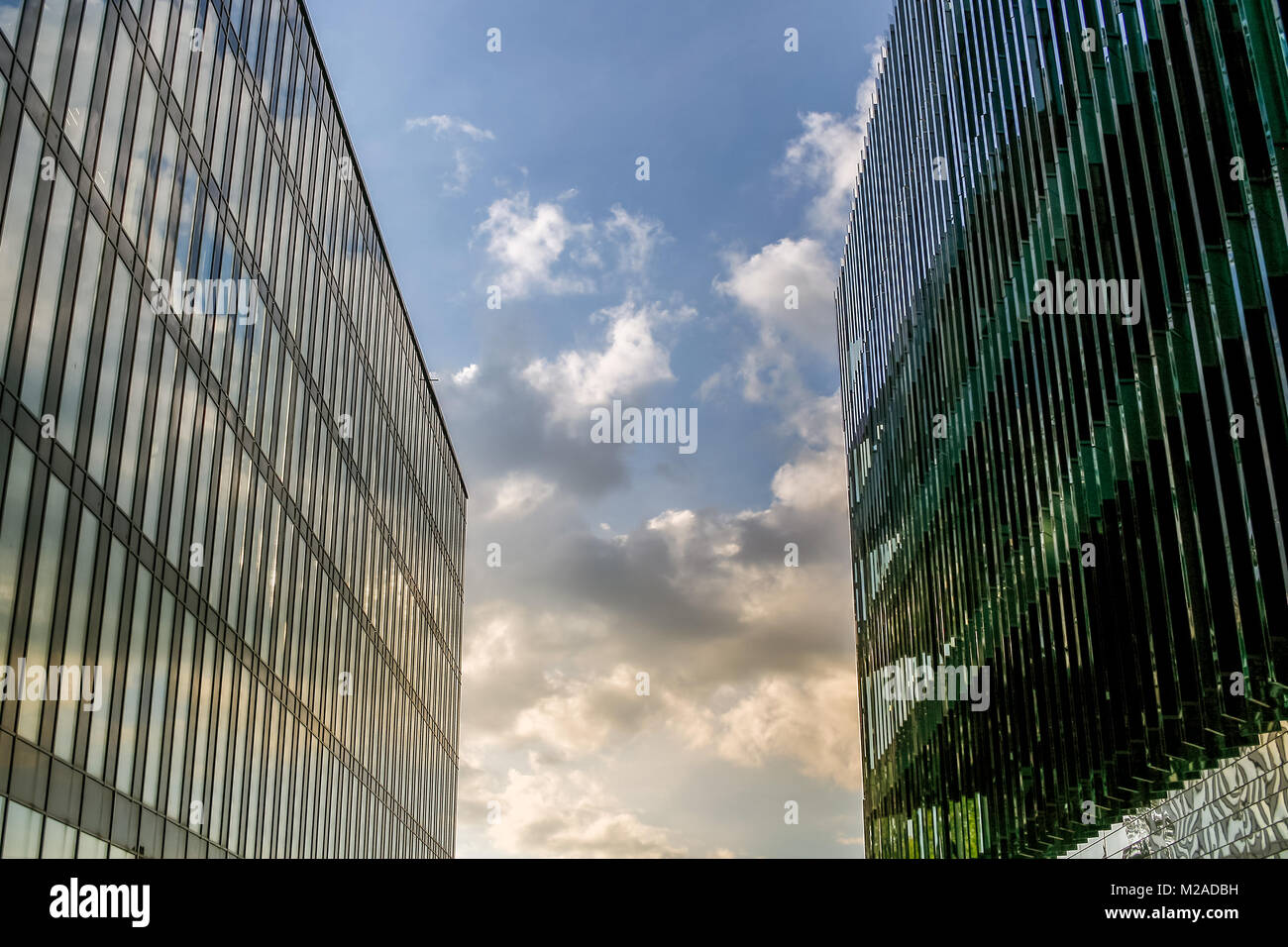 Two large modern buildings stand close to each other, closing the sky. Stock Photo