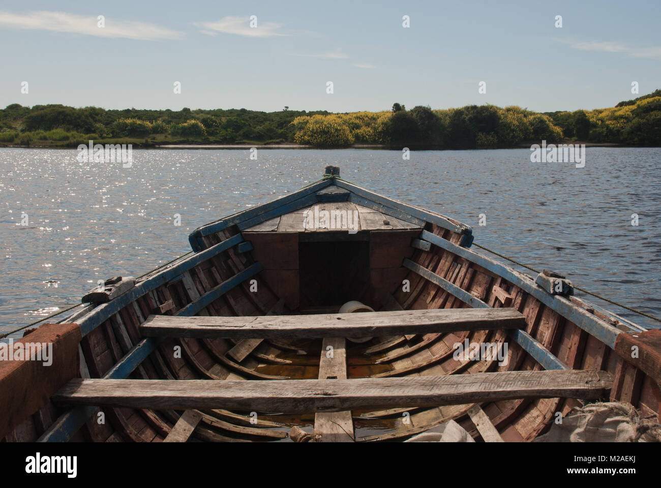 The inside of a wooden rowing boat floating on a lake in Patagonia