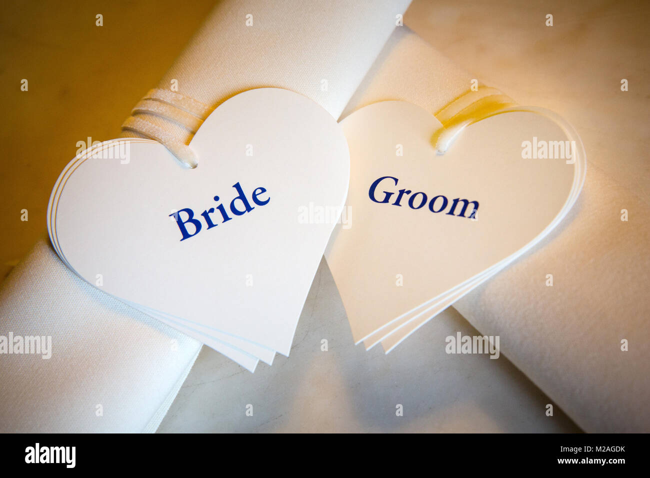 Two scrolls with bride and groom heart shaped labels, close-up Stock Photo