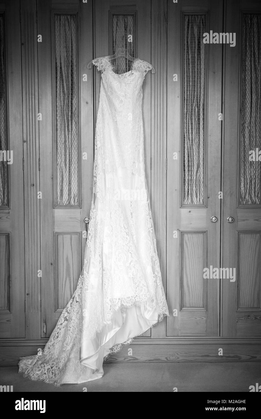 Wedding dress hanging on door, black and white Stock Photo