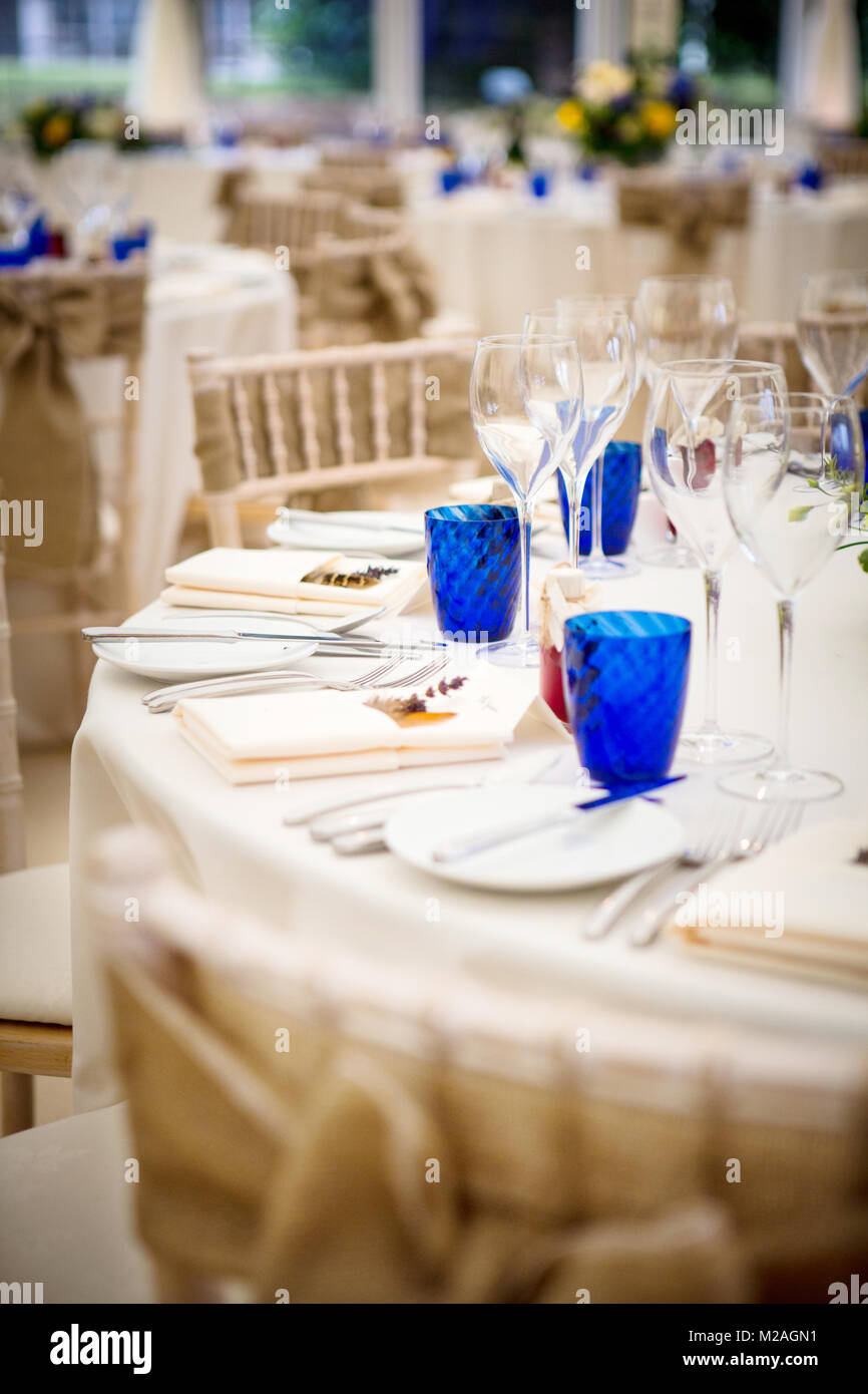Wedding Reception Tables With Place Settings And Wine Glasses