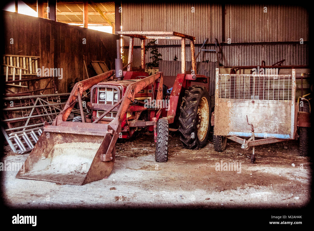 Vintage International Tractor in a farmers barn, in Dorset UK Stock Photo
