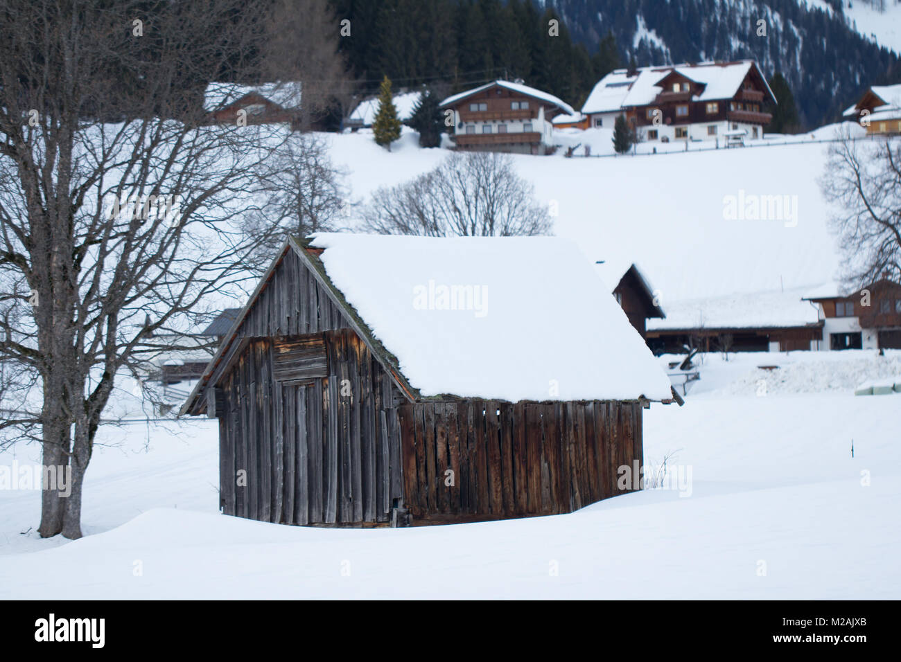 wood hut in winter snowy landscape Stock Photo