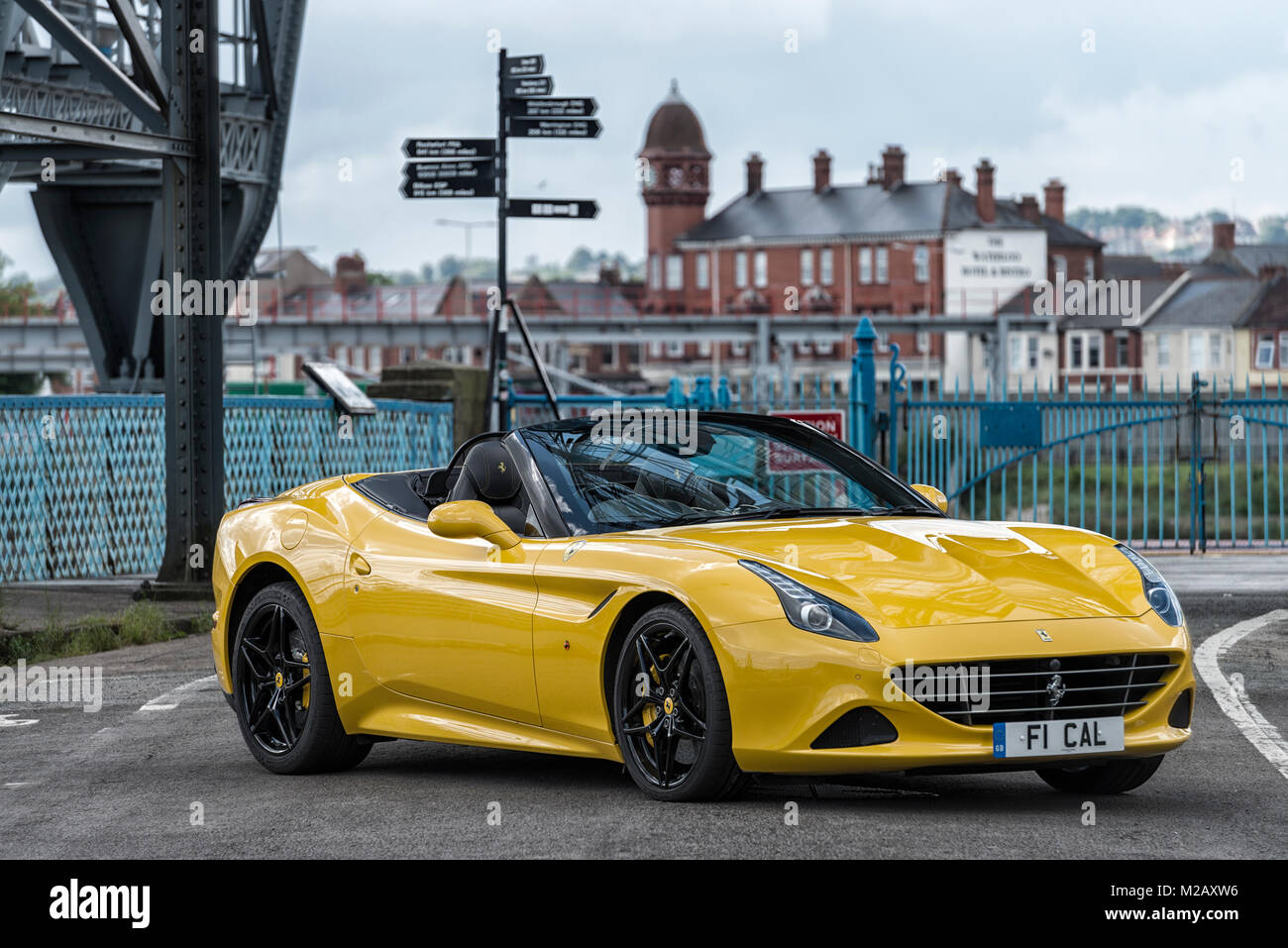 A yellow Ferrari F1 California pictured at Newport Transport Bridge, Pill, South Wales. Stock Photo