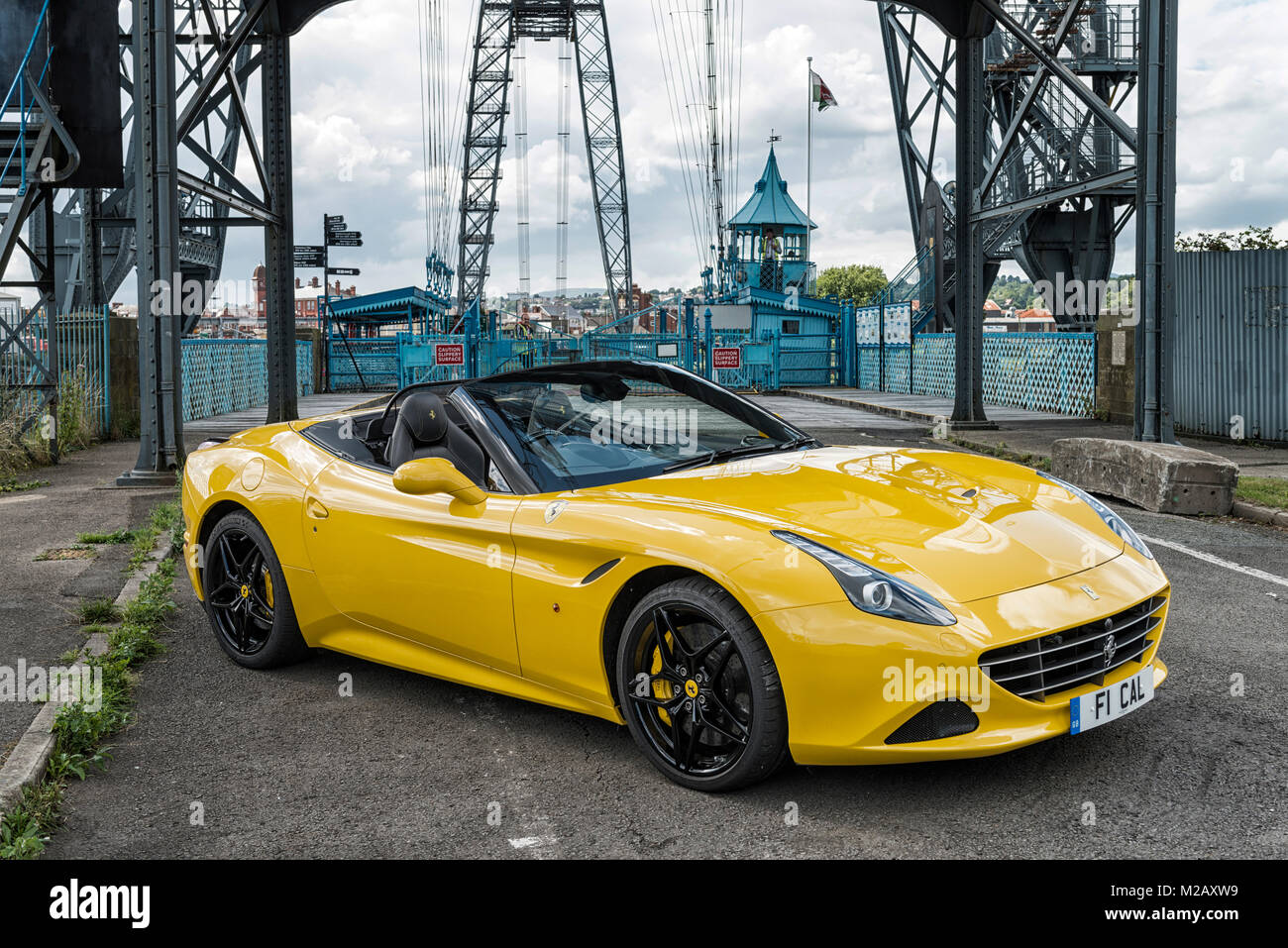 A yellow Ferrari F1 California pictured at Newport Transport Bridge, Pill, South Wales. Stock Photo