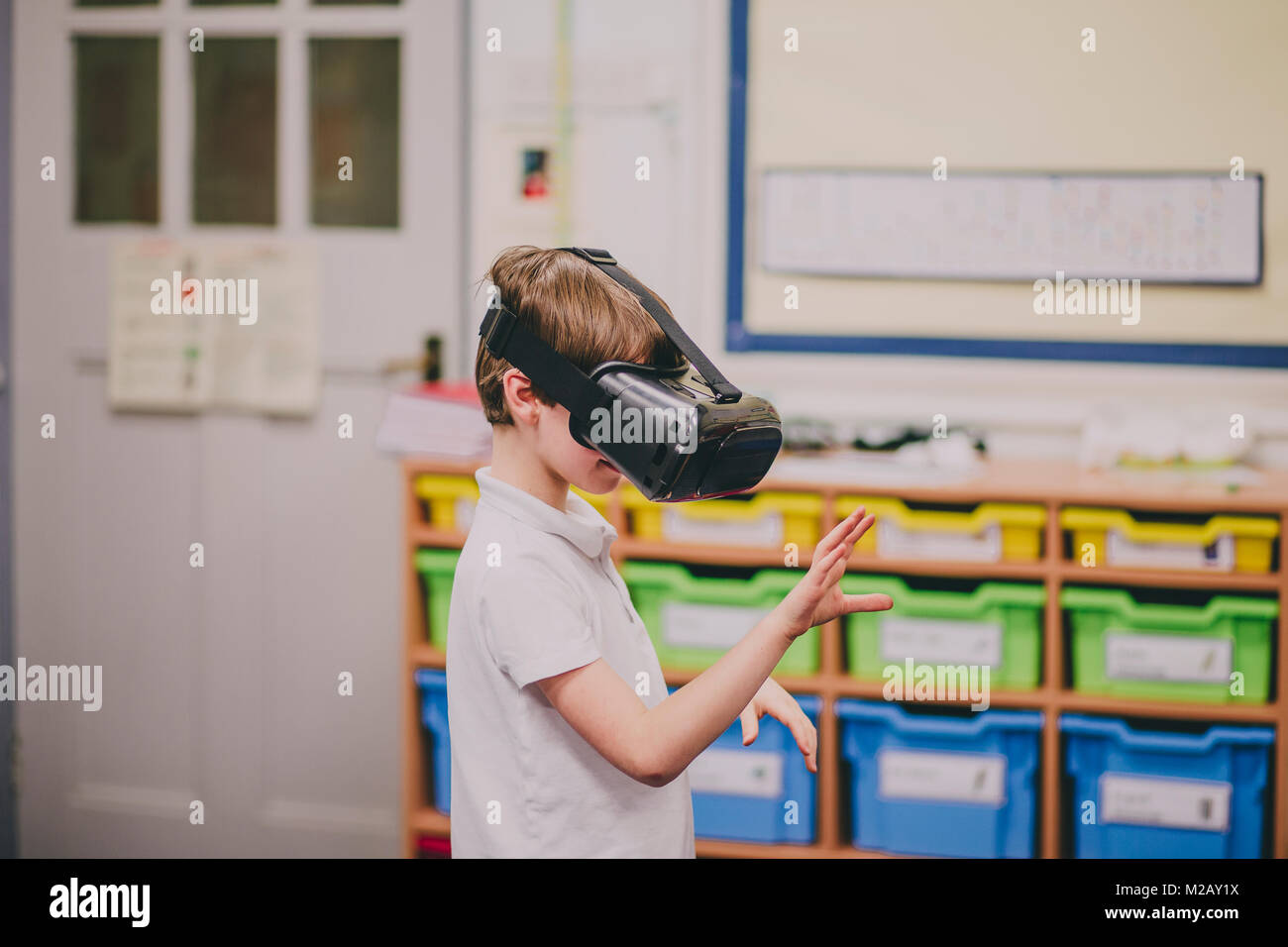Little boy is experimenting with virtual reality in the classroom at ...