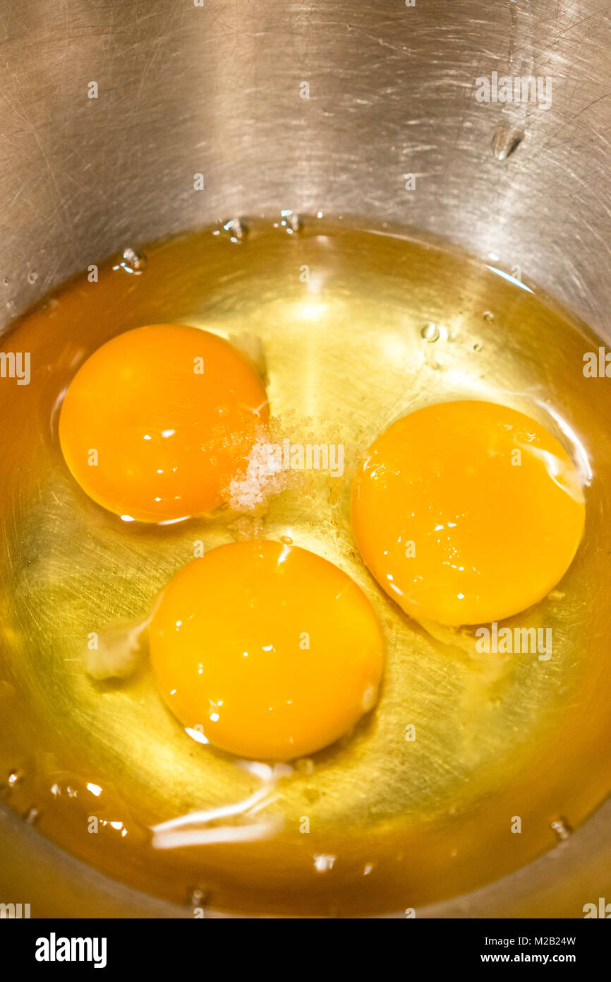 Three eggs in an iron bowl Stock Photo Alamy