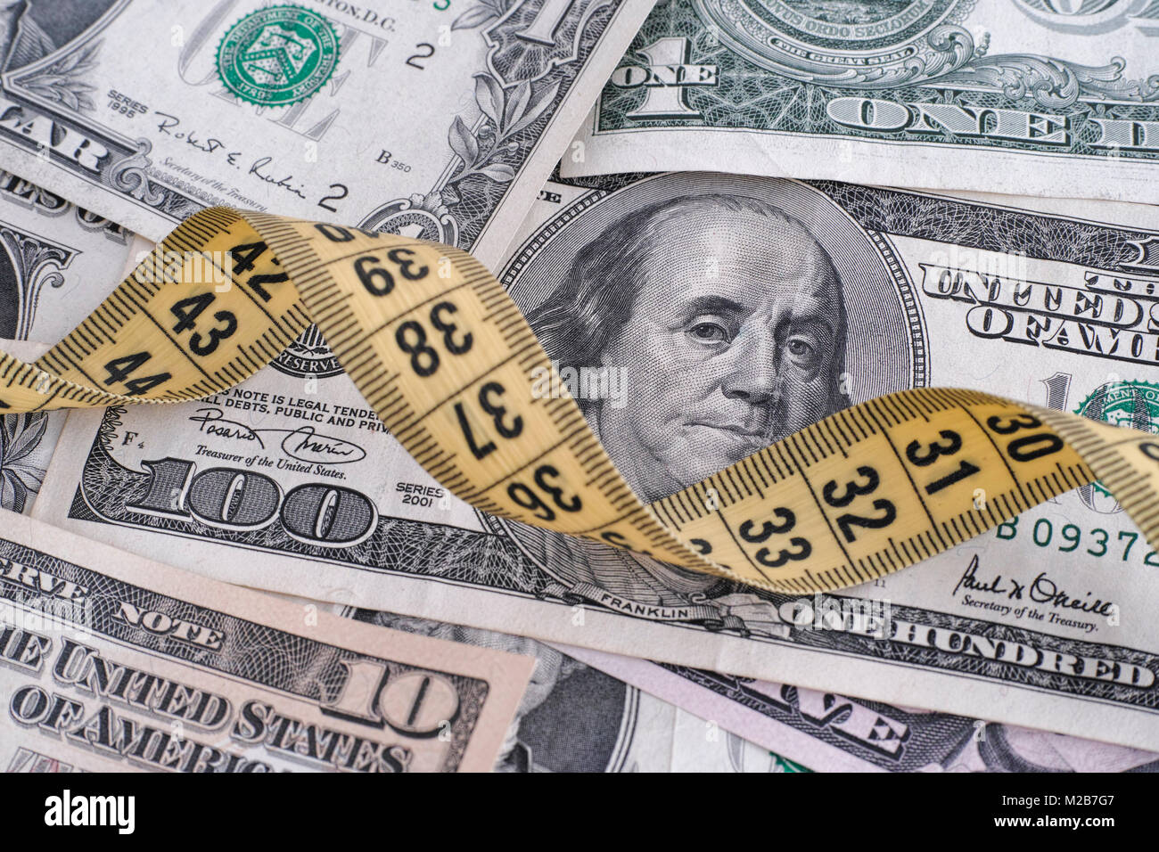 Dollar bills and yellow tape measure. Close up Stock Photo Alamy
