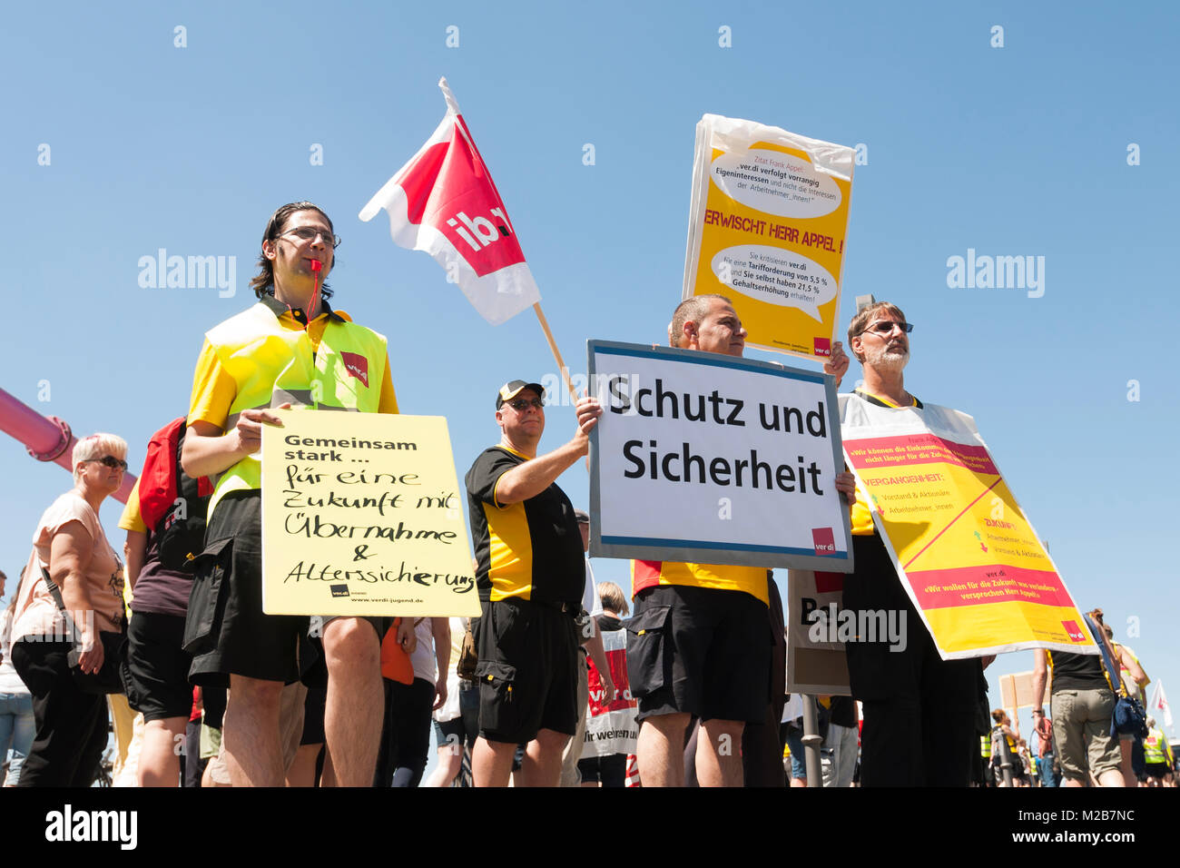post and dhl employees demonstrate in sight (not included in the restricted area) of the federal chancellery. with the action,the union wants the federal government to its responsibility for preserving the uniform supply of the population with postd Stock Photo