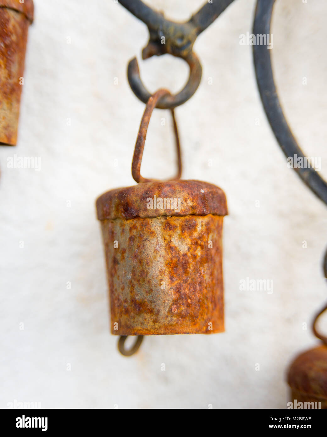 Close up of rusty bells on a hand made metal wind chime Stock Photo