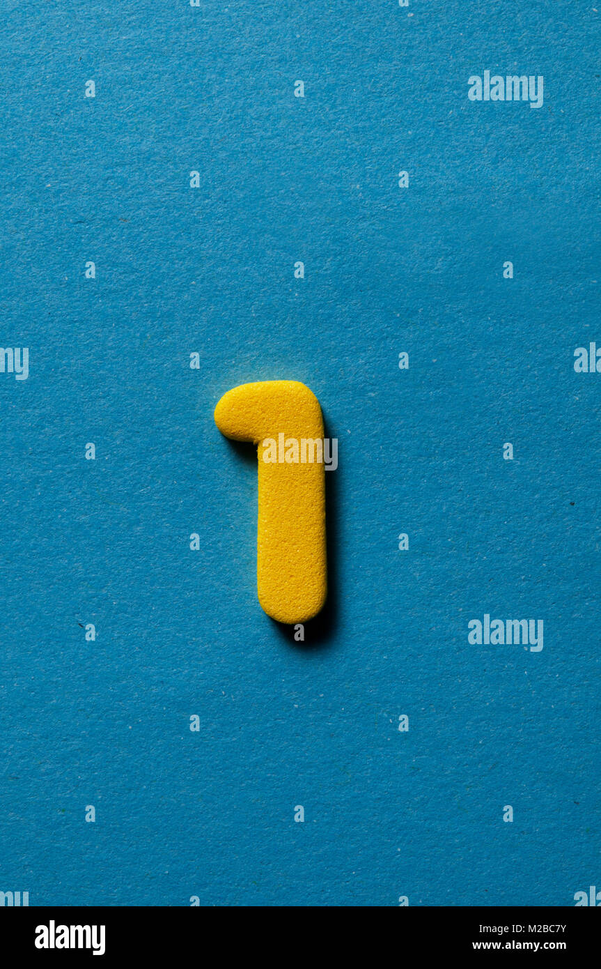 yellow number one on blue background Stock Photo