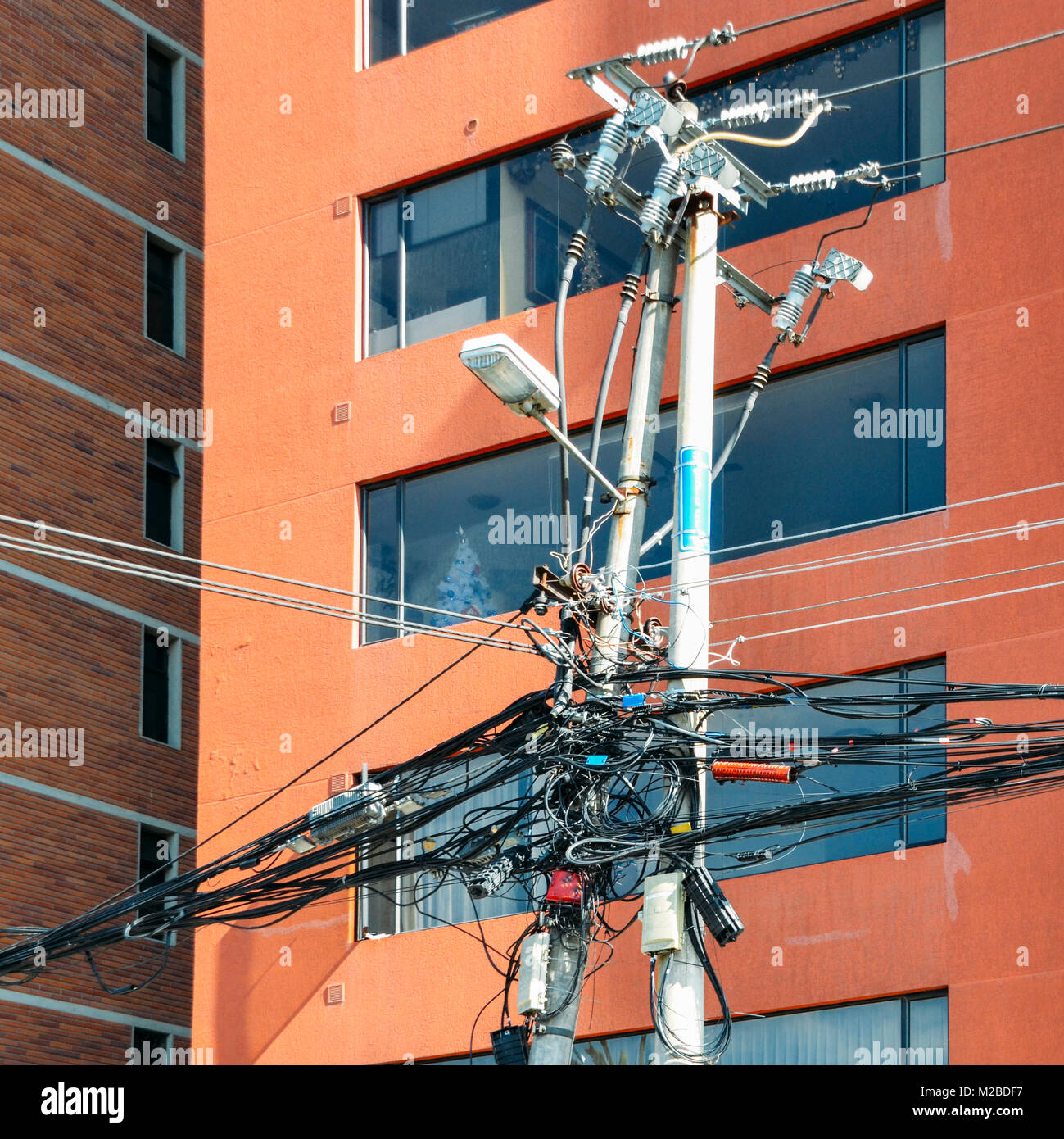 Tangled electric wires on a street lamp in Quito, Ecuador Stock Photo