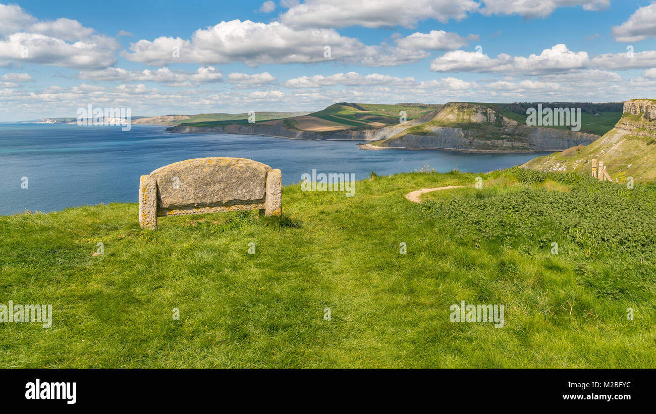 Stone bench at the South West Coast Path with a view over the Jurassic Coast and Emmett's Hill, near Worth Matravers, Jurassic Coast, Dorset, UK Stock Photo