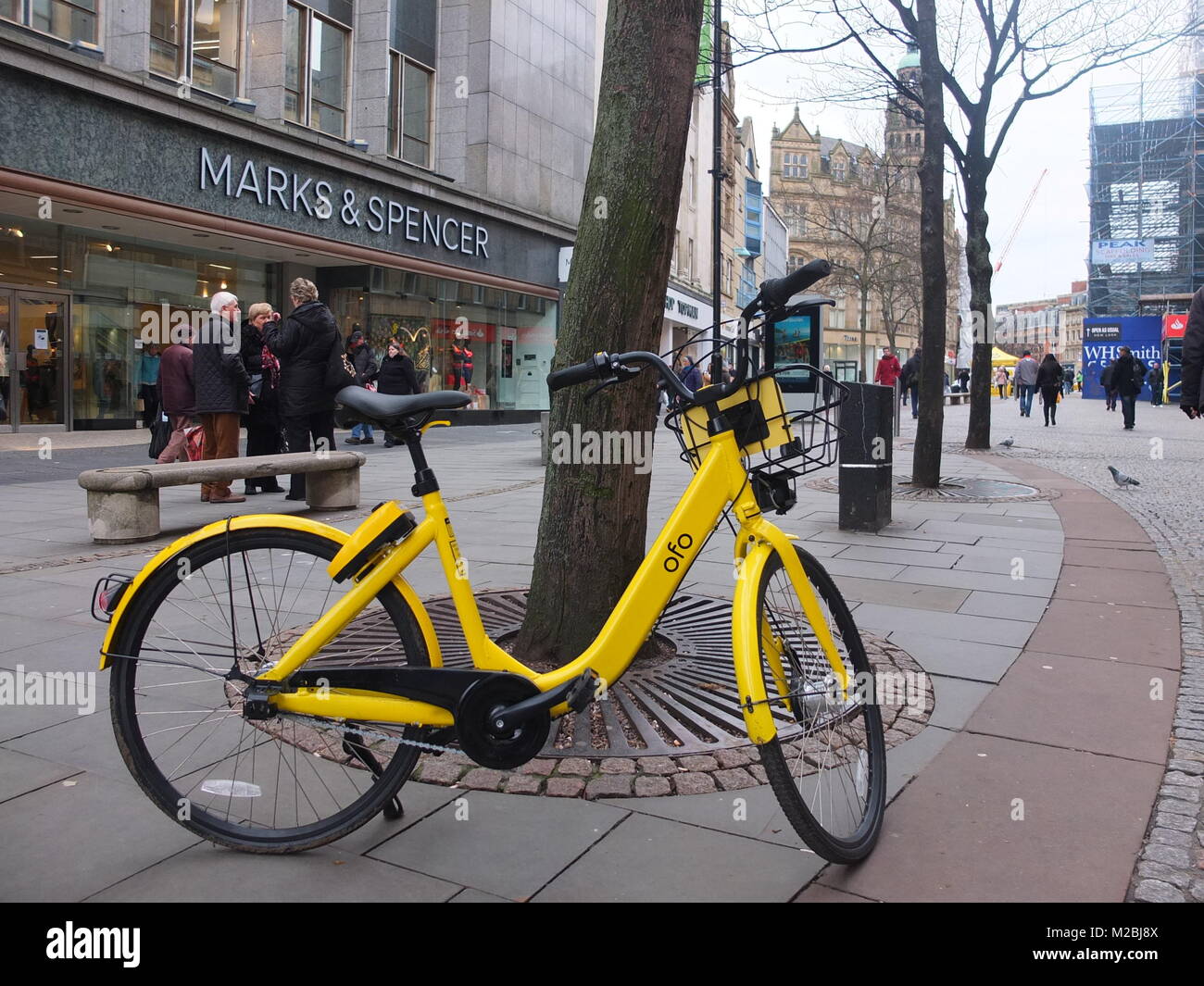 Yellow Ofo hire bike left on Fargate in Sheffield city centre. The