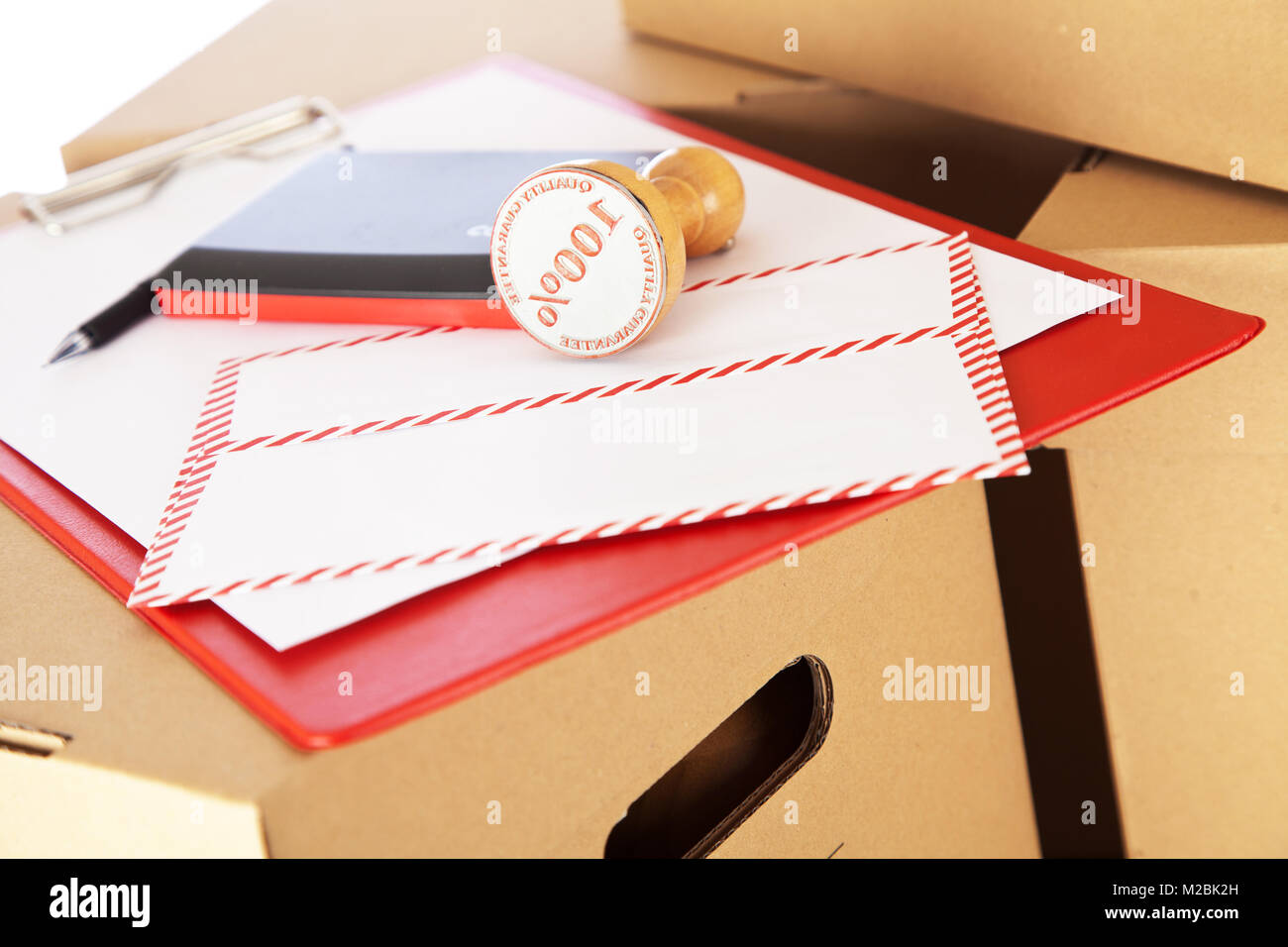 Mail envelope on cardboard boxes Stock Photo