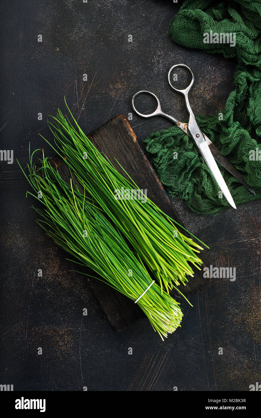 green onion on board and on a table Stock Photo - Alamy