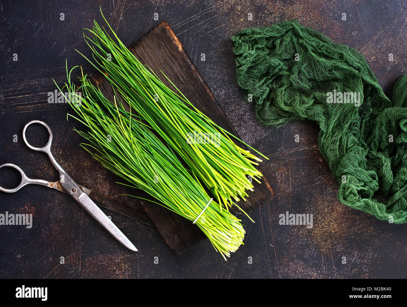 green onion on board and on a table Stock Photo - Alamy