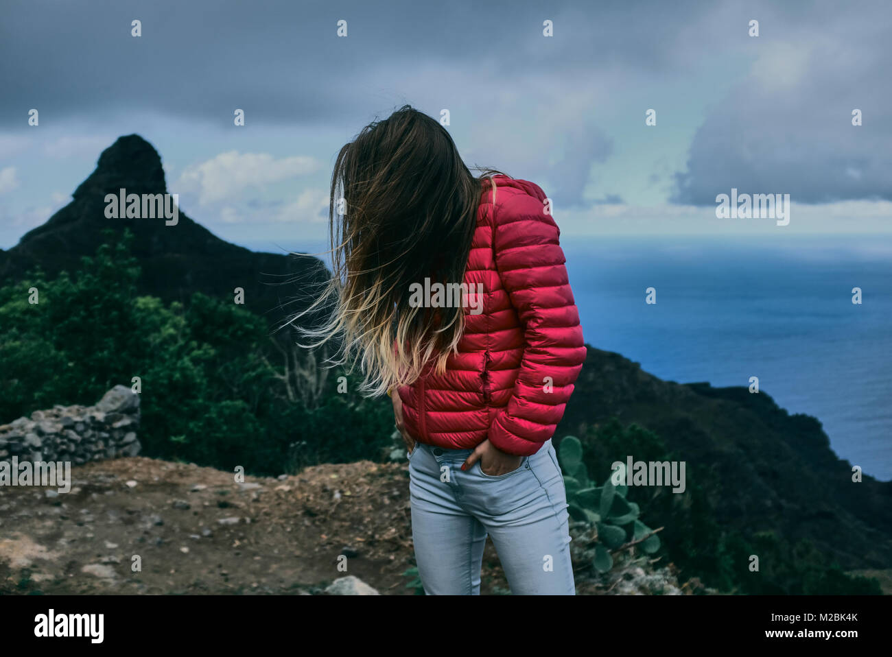 Pretty girl of background of mountain landscape Stock Photo - Alamy