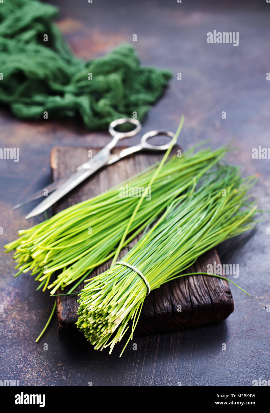 green onion on board and on a table Stock Photo - Alamy